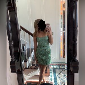 A beautiful green homecoming dress with a sequin floral pattern! Lovely dress!